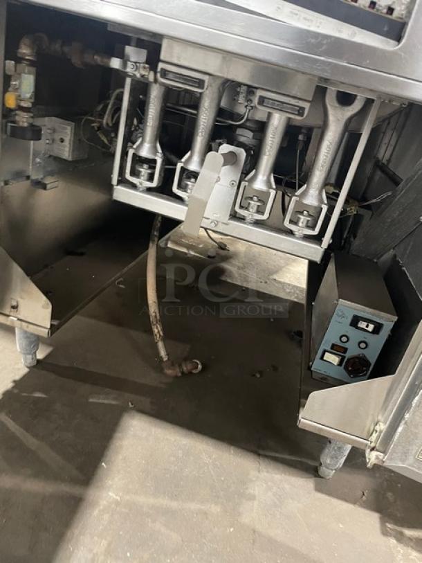 Pitco DD24RUFM stainless steel donut fryer, 117 lb. capacity, natural gas, 120V 1 Phase, with backsplash, on legs.