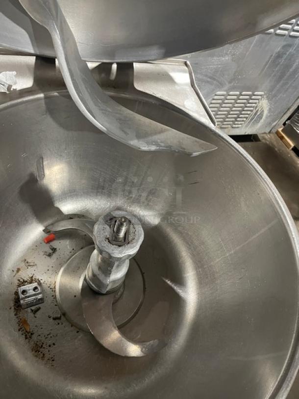 Hobart VCM40 commercial mixer with stainless steel tilting bowl, lid included. Heavy-duty blades visible. Good condition.