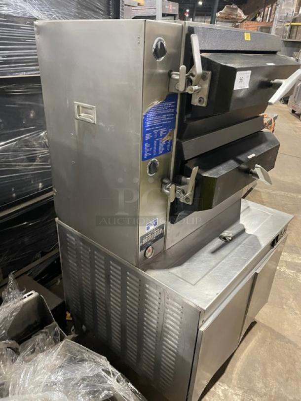 Cleveland Range stainless steel 2-compartment pressure steamer with individual controls, built-in pan slides, and enclosed cabinet base. Natural gas powered.