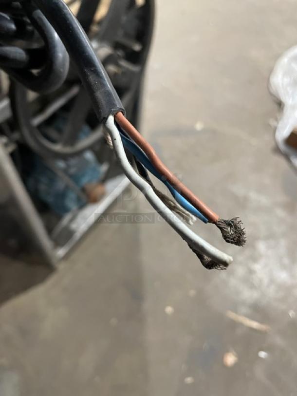 Close-up of frayed electrical wires from a commercial stainless steel meatball forming machine, 220V 3 Phase, used condition.