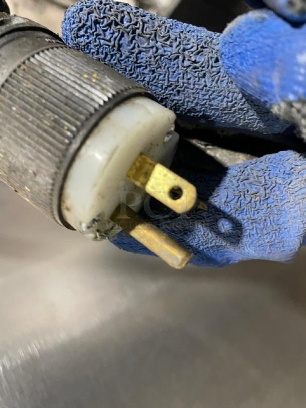 Close-up of plug for Groen AH/1-40 steam kettle, showing three-pronged connector, part of natural gas-powered appliance.