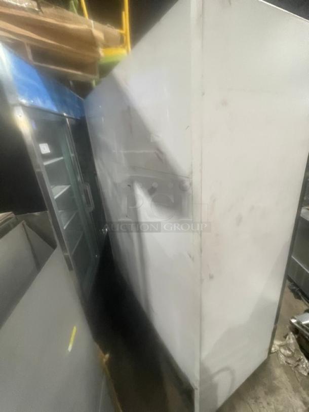 True Commercial black double glass swing door reach-in merchandiser freezer, Model GDM-49F, with poly-coated wire rack.