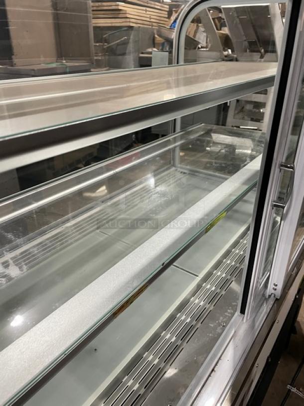Avantco 48" curved glass bakery display, model 193BC48HCW, with adjustable shelves, rear sliding doors, excellent condition.
