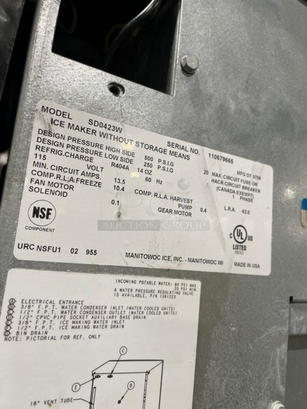 Manitowoc ice machine, model SD0423W/QPA160, stainless steel, water-cooled, electric, 115/120V, 1 phase, on legs. Tags show specs.
