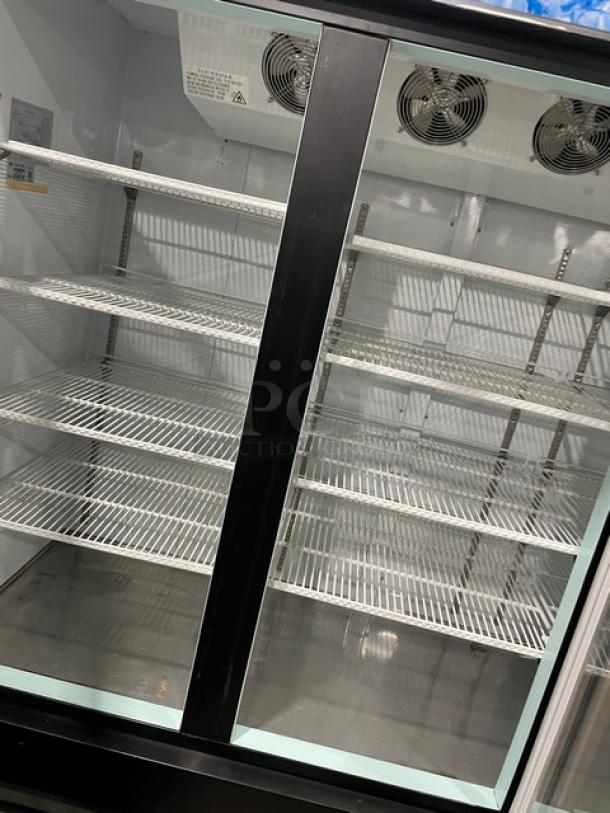 Spartan SGM72RS commercial refrigerator, black powder-coated, triple glass swing doors, poly coated wire racks, on casters.