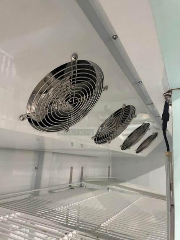 Spartan SGM-72RS commercial refrigerator interior view, showcasing fans and poly-coated wire racks.