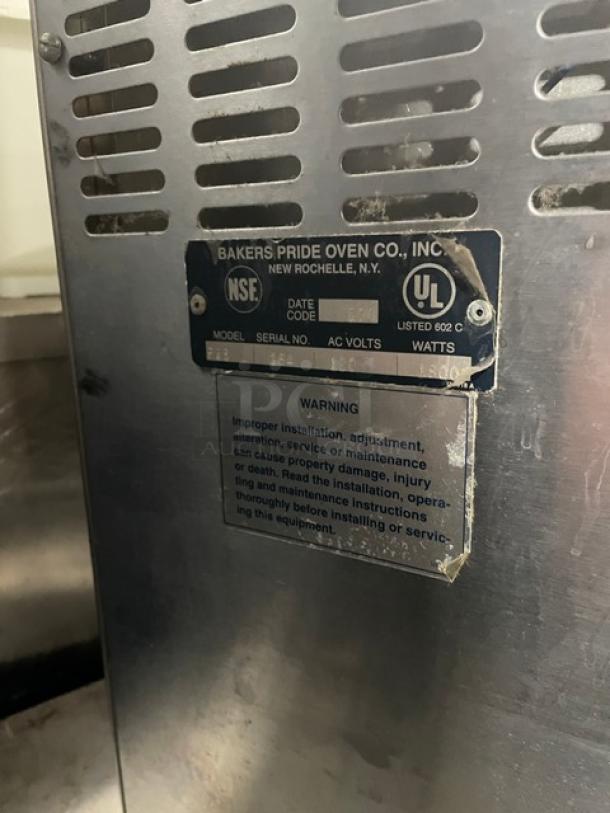 Bakers Pride P18 electric countertop pizza oven, stainless steel, single chamber, double deck, model and safety labels visible.