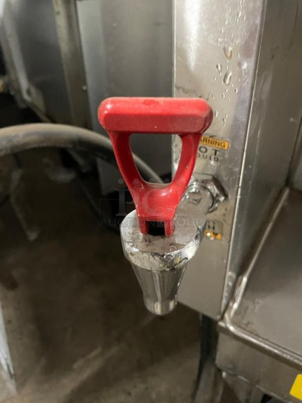 Bunn commercial coffee brewer, model DUALSHDBC, with red hot water dispenser tap. Stainless steel and digital controls.