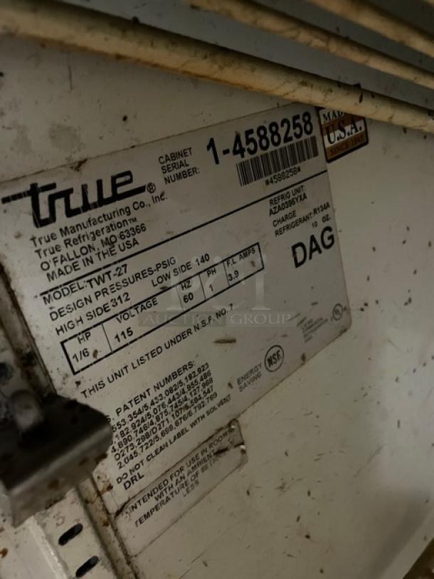 True TWT-27 commercial stainless steel refrigerator label. Model, serial number, specifications visible.