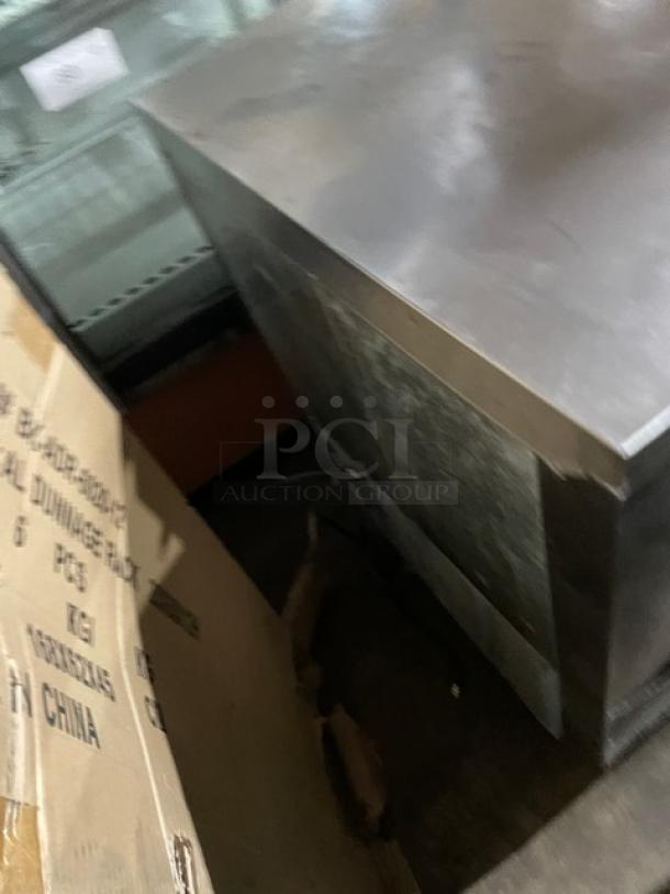 Leader commercial stainless steel undercounter refrigerator NSFB27SC, with poly coated wire rack, on legs, 115V, used.