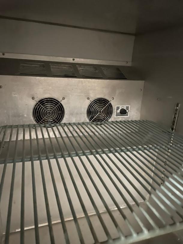 Leader NSFB27SC stainless steel single door undercounter refrigerator with poly-coated wire rack, interior view showing fans.