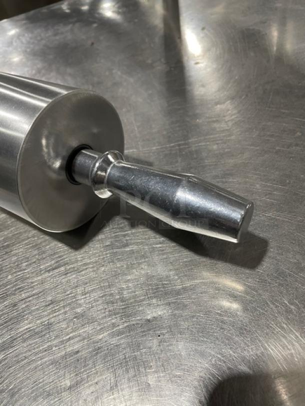 New commercial heavy-duty metal rolling pin on a steel surface, features durable construction, ideal for professional use.