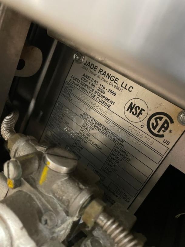 Jade Range stainless steel gas 4-burner range/oven, model JBR424, SN 0000048816VL, with wired oven rack, on legs.