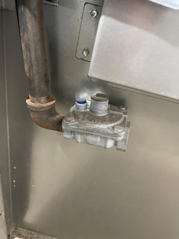 Close-up of gas connection on Jade Range JBR424 commercial stainless steel gas-powered 4-burner range/oven combo.