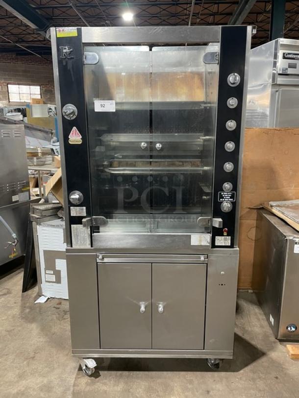 Rotisol Model 9505 stainless steel rotisserie oven, natural gas, tempered glass doors, 2-door cabinet base, retractable workstation.