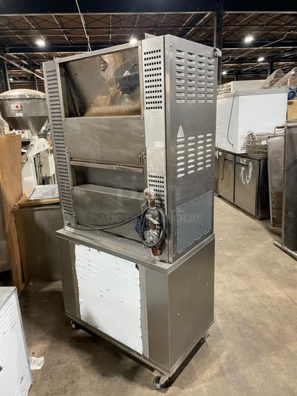 Rotisol stainless steel natural gas rotisserie oven, model 9505, on casters. Features tempered glass doors, 2-door cabinet base, and pull-out workstation.