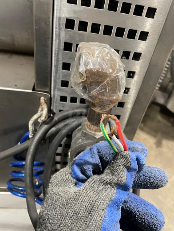 Rotisol Model 9505 commercial rotisserie oven, stainless steel, with wires and gas connection. Features include tempered glass doors and retractable workstation.