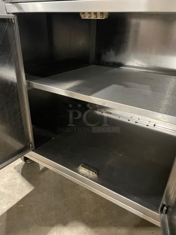 Rotisol Model 9505 commercial stainless steel rotisserie oven with enclosed cabinet base, tempered glass doors, and casters.
