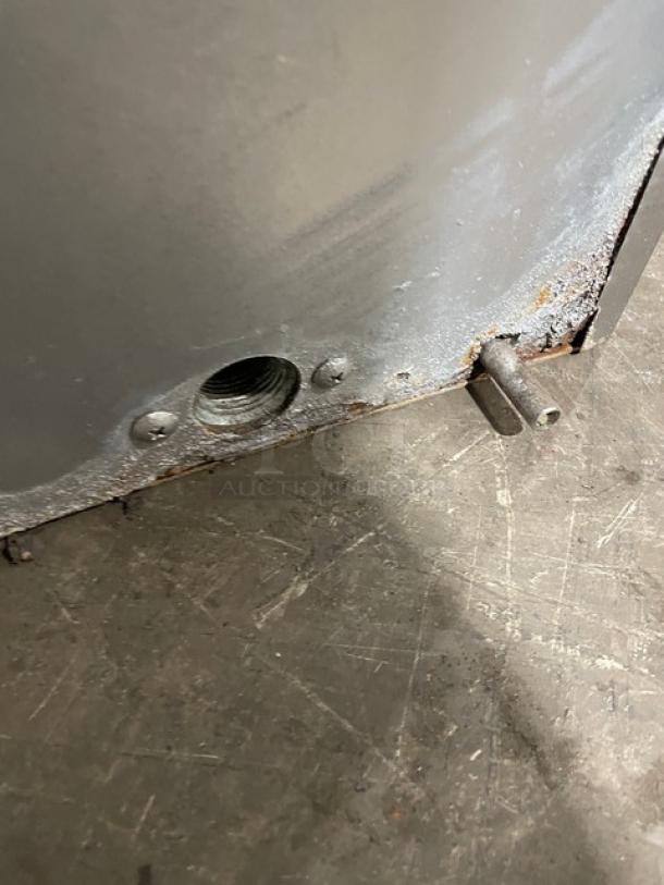 Hoshizaki KM-515MAH ice machine; stainless steel, air-cooled, crescent-cube style. Minor rust visible near bottom edge. Model: KM-515MAH.