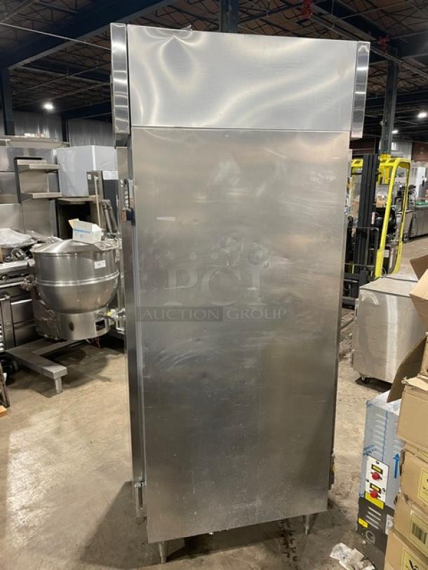 Continental Commercial stainless steel pass-thru refrigerator, model DL1REPT, single door, built-in pan slide, on legs.