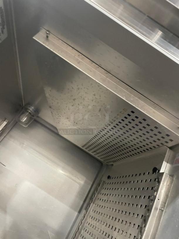 Continental DL1REPT stainless steel pass-thru refrigerator interior, built-in pan slide, model DL1RE-PT, serial 14738886.