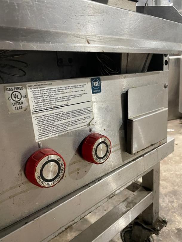 Lang 224THNATMG stainless steel countertop infrared clamshell griddle on a stand. Features gas controls, NSF-certified.