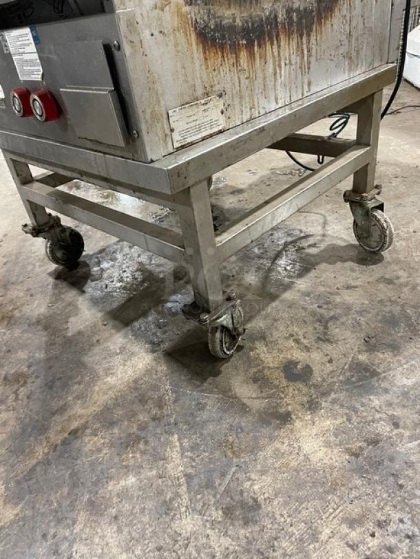 Lang 224TH-NATMG stainless steel countertop infrared clamshell griddle on casters; includes equipment stand; natural gas powered; used condition with visible wear.