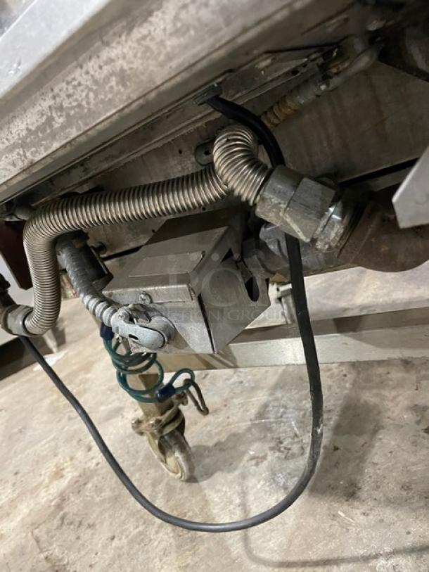 Lang commercial stainless steel infrared clamshell griddle, model 224THNATMG, on casters. Features gas connections.