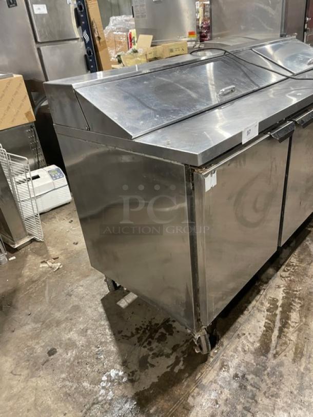 Beverage-Air SPE72-18 3-door refrigerated prep table, stainless steel finish, poly-coated rack, on casters.