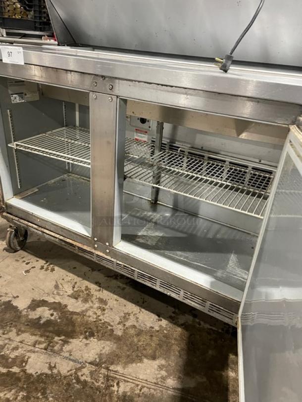 Beverage-Air Elite Series 3-door refrigerated prep table, Model SPE7218, stainless steel, on casters, with poly-coated rack.