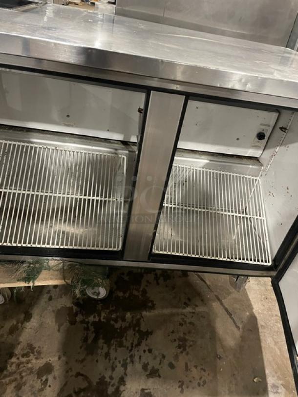 True TSSU-72-08 stainless steel 3-door refrigerated prep table. Includes poly coated wire rack. 72-inch. Model: TSSU-7208.