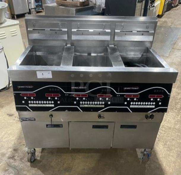 Henny Penny Evolution Elite EEG253 triple bay fryer, stainless steel, natural gas, backsplash, basket hanger, on casters.