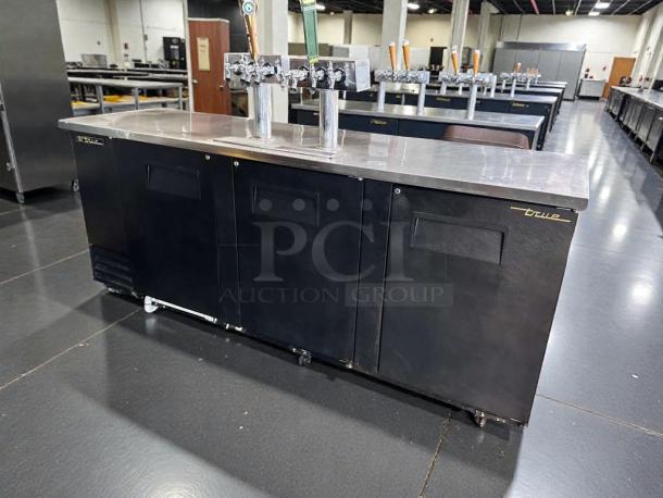 TRUE TDD-4 commercial draft beer dispenser, stainless steel top, black exterior, four taps, on casters. Stellar condition.