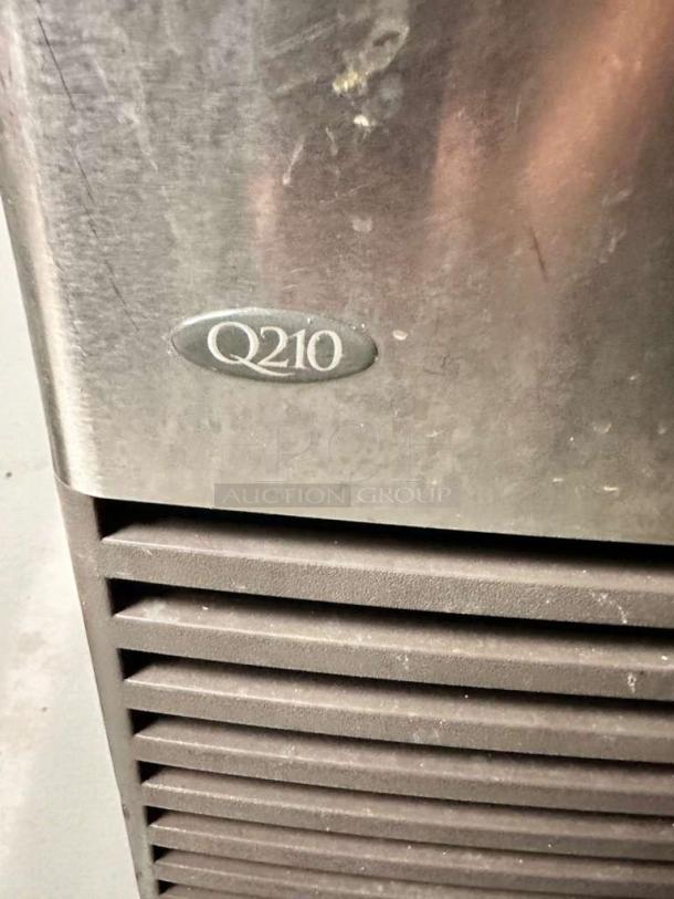 Manitowoc Q210 ice machine in pristine condition, undercounter model, dice cube ice, fully tested, visible Q210 label.