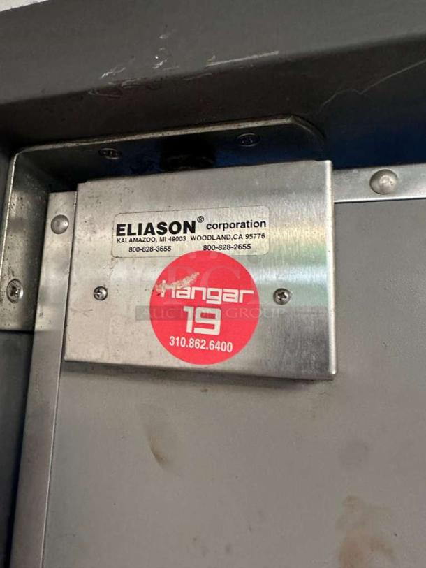 Eliason Hangar 19 commercial walk-in traffic door, outstanding condition, fully tested. Features label with model and contact info.