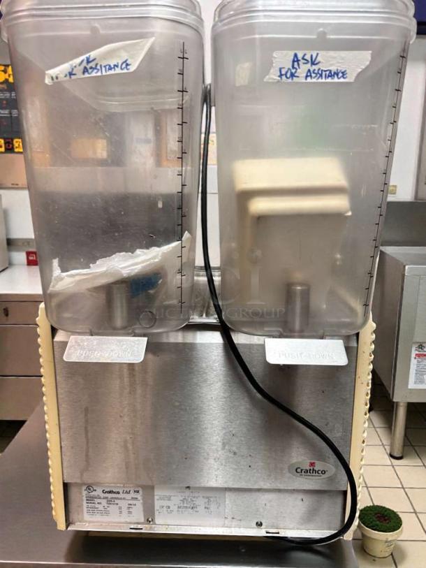 Crathco D25-4 dual beverage dispenser, 115V, Grindmaster Corp., excellent condition, clear tanks, labels "ASK FOR ASSISTANCE."