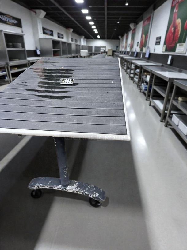 (x4) Commercial patio tables in outstanding condition, weather-resistant, metal frame with caster wheels, ready to use.