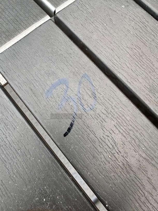 Weather-resistant patio table surface with wood-like texture and numbered marking "30" in blue. Fully inspected, ready to use.