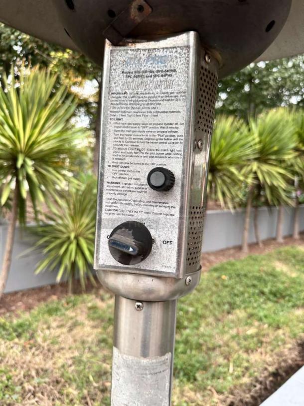Stainless steel patio heater with control panel and markings; model SPC-54PH listed, in superior condition.