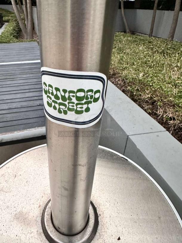 Set of three stainless steel outdoor patio heaters in superior condition, mushroom-top design, tested and ready for use.