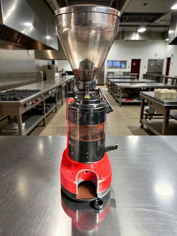 Premium condition commercial coffee grinder, 120V, red base, transparent hopper, fully tested and working, on stainless steel counter.