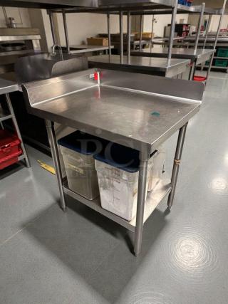 Pristine commercial stainless steel work table with backsplash, fully cleaned, storage shelf, ideal for professional kitchens.