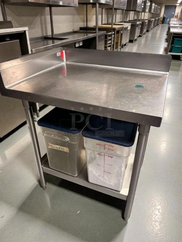 Commercial stainless steel work table with backsplash in pristine condition, fully cleaned. Includes under-shelf with storage.