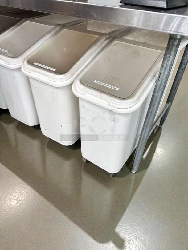 Three Cambro ingredient bins with slanted lids, in superb condition, labeled for contents, on wheels for mobility.