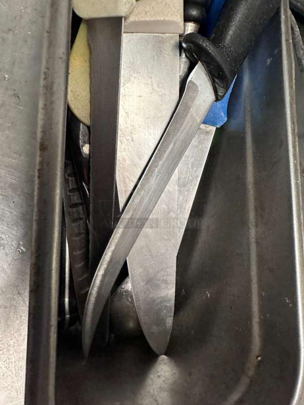 Assorted commercial kitchen knives in premium condition, mixed brands, inspected, and ready for use; blades and handles visible.