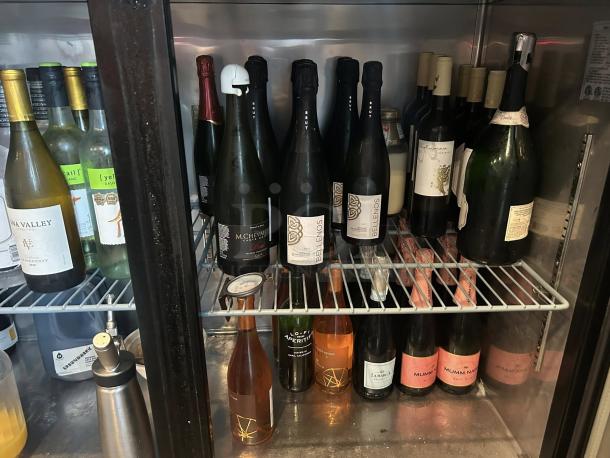 Pristine Migali BB60-N12 back bar refrigerator with two glass doors. Tested, working condition. Shelves stocked with bottles.