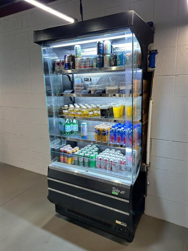 Turbo Air TOM-40B-SP-N vertical open air cooler, premium condition, stocked with beverages, fully tested, working.