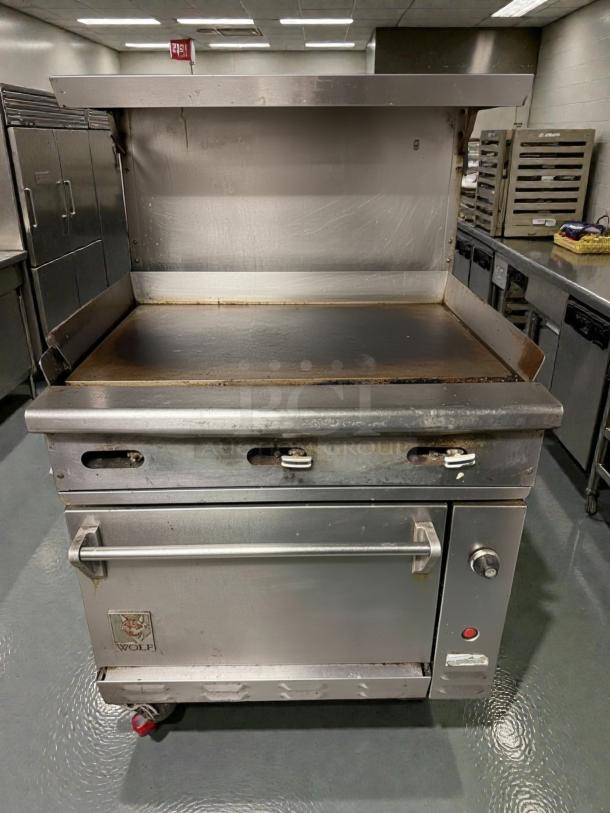 Wolf C36S-36G commercial gas range in superior condition with full griddle and standard oven; tested and working.