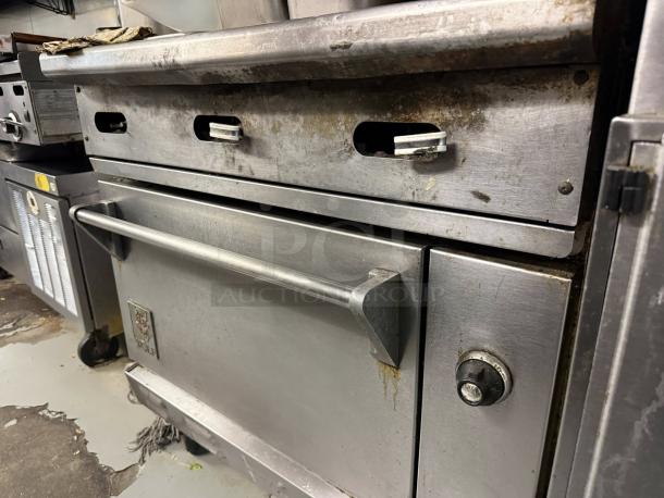 Wolf C36S-36G commercial gas range with full griddle and standard oven, superior condition, tested working.