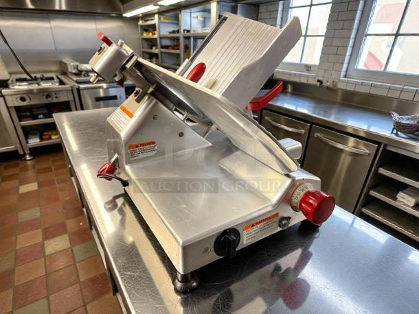 Berkel B12-SLC 12" manual gravity-feed meat slicer, 1/2 HP, excellent condition, tested and working, visible safety markings.